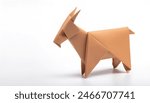 Animal concept paper origami isolated on white background of a goat with pointy horns with copy space representing equality or following others