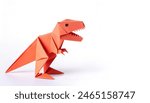 Animal extinct reptile or bird concept origami isolated on white background of a tyrannosaurus rex or T rex, with copy space, simple starter craft for kids