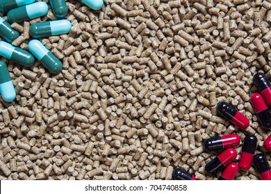 Animal Feed Pellets And Pill Capsules As Background, Antibiotics In Livestock Feed Concept.