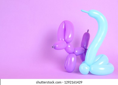 Animal Figures Made Of Modelling Balloons On Color Background. Space For Text