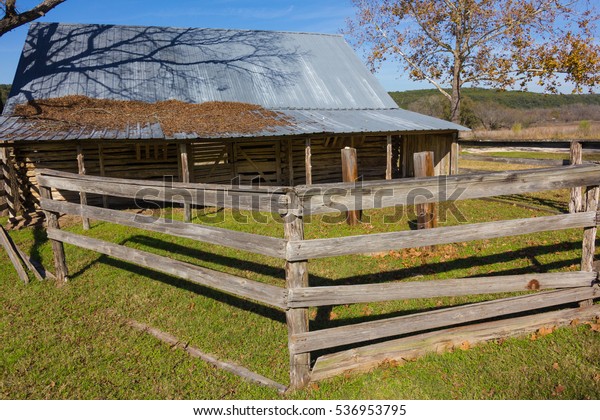 animal pen and old barn\
with a tin roof
