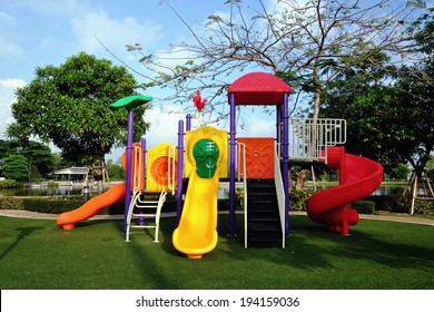 Animal Style Colorful Slides On Artificial Grass Playground In Park With Sun Shine And Blue Sky