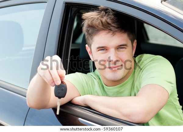 Animated caucasian man holding a car key sitting in\
his car