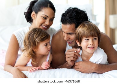 Animated family having fun lying on bed at home - Powered by Shutterstock