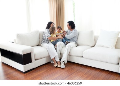 Animated family having fun sitting on sofa at home - Powered by Shutterstock