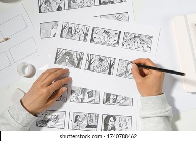 The animator artist draws in pencil a storyboard for the cartoon. Pre-production for the video film. The designer creates sketches for the comics.  - Shutterstock ID 1740788462