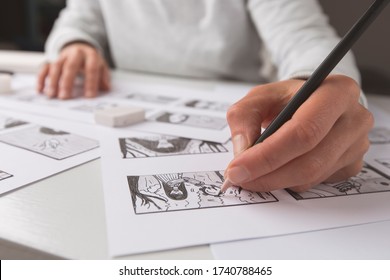 The animator artist draws in pencil a storyboard for the cartoon. Pre-production for the video film. The designer creates sketches for the comics.  - Shutterstock ID 1740788465