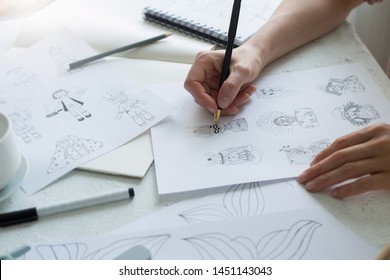 Animator Designer Draws Sketches Of Various Characters. Creating Illustrations On Paper For Cartoons Or Video Games.