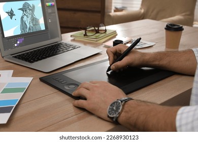 Animator working with graphic tablet and laptop, closeup. Illustration on screen - Shutterstock ID 2268930123