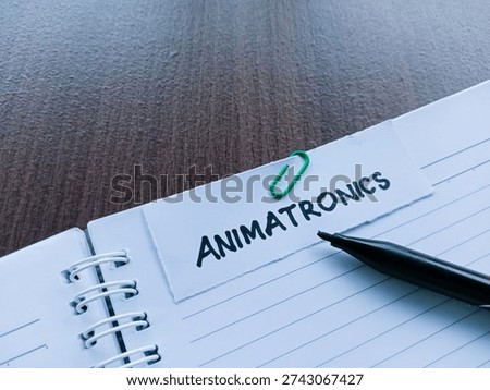 Animatronics writting on table background. 
