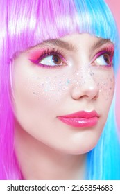 Anime makeup. Pretty girl with bright makeup, glitter freckles and in colored violet-blue wig. Pink background. Hairstyle, hair coloring, make-up. Japanese anime style.  - Shutterstock ID 2165854683