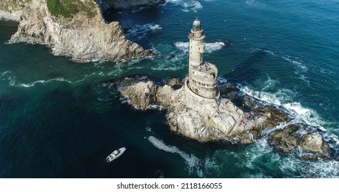 Aniva lighthouse, visitors are unloading from the boat. Aerial photography