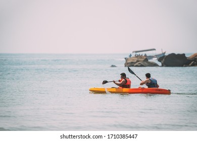 Anjadip, Goa, India - February 16, 2020: Two Men Swiming In Arabian Sea Kayaking In Summer Sunny Day