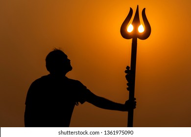 Anjuna, Goa / India - January 18 2019: A Tourist Posing With A Trishul Which Is Installed On The Rocks Near The Beach Giving Pose Of Mahadev Or Shiva