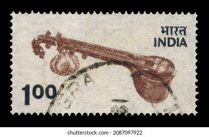 Ankara, Türkiye - 12,07,2021: An India postage stamp shows  Local Motifs Indian national musical instrument sitar on a white background. Circa 1975