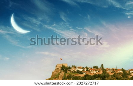 Ankara Kalesi - Historic center of Ankara - View of Ankara Castle, moon and rainbow in blue sky.