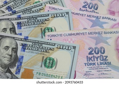 Ankara, Turkey  - 12.20.2021: Turkish Lira and American Dollars. Financial crisis, devaluation and exchange rates themed banknotes close-up. 100 US Dollars and 200 Turkish Liras. USD and TRY