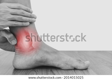 Ankle, joint pain, and tendon problem. a man touching ankle