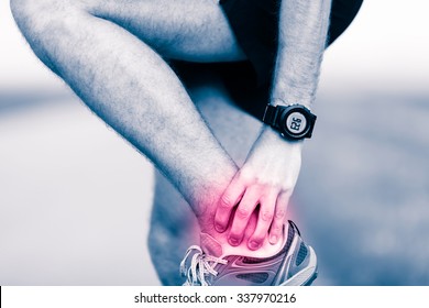 Ankle Leg Pain, Man Holding Sore And Painful Foot Muscle, Sprain Or Cramp Ache Filled With Red Pink Bright Place. Overtrained Injured Person When Training Exercising Or Running Outdoors.