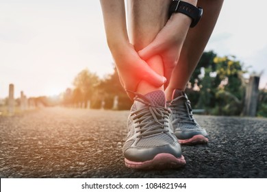 Ankle twist sprain accident in sport exercise running jogging.sprain or cramp Overtrained injured person when training exercising or running outdoors. - Shutterstock ID 1084821944