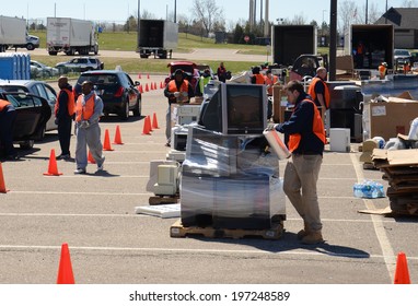 ANN ARBOR, MI - APRIL 26:  A Worker Wraps A Pile Of Electronics At An Electronic Recycling Event In Ann Arbor, MI April 26, 2014.