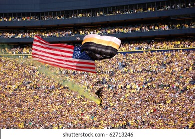 ANN ARBOR, MI - OCTOBER 09: 101st Airborne Division Parachute Demonstration Team member parachutes past the crowd before the Michigan vs. Michigan State football game October 9, 2010 in Ann Arbor, MI.