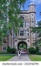 Ann Arbor, Michigan - September 12, 2010:  A Student Walks Toward An Arch In A Gothic Stone Building To Exit A Courtyard At The University Of Michigan