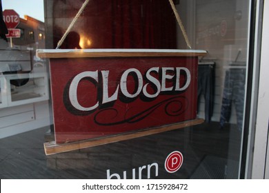 Ann Arbor, Michigan / United States - April 26 2020: Sorry We're Closed Wooden Closing Sign Covid- Governor Gretchen Whitmer Extends Stay At Home Order Michigan Coronavirus Closed Sign