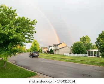 Ann Arbor, Michigan USA - 05 05 2019: Sky rainbow over city Ann Arbor . Rainbow over the city of  Ann Arbor, Michigan USA. Rainbow over the blue sky in spring, residential area. Closeup. Background.

