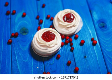 Anna Pavlova Cakes On Blue Wood With Cranberries