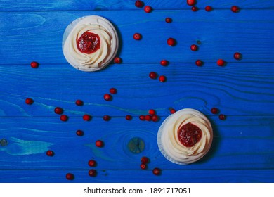 Anna Pavlova Cakes On Blue Wood With Cranberries