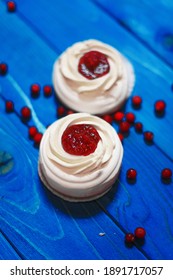 Anna Pavlova Cakes On Blue Wood With Cranberries