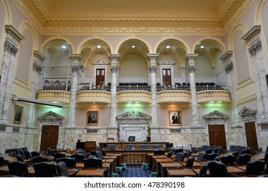 ANNAPOLIS, MARYLAND, USA - OCTOBER 16, 2015. Interior view of the House of Delegates Chamber of the Maryland State House in Annapolis, with furniture, portraits, flags, balconies, columns.