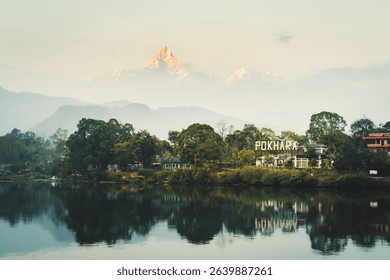 Annapurna mountain range reflection view on lake at sunset. Pokhara city and Phewa Lake, central Nepal. Annapurna mountain range snowy peaks