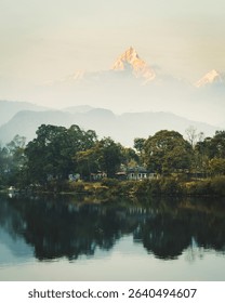 Annapurna mountain range reflection view on lake at sunset. Pokhara city and Phewa Lake, central Nepal. Annapurna mountain range snowy peaks