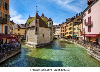 Annecy, France - 19 April 2022: Palais de l’Isle, a medieval stone house on river Thiou, is the main landmark and a popular tourist attraction in Annecy Old town, France
