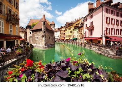 ANNECY, FRANCE - MAY 13: People walk around the River Thiou in Old Town, encircling the medieval palace perched mid-river - the Palais de l'Isle on May 13, 2012 in Annecy, France.