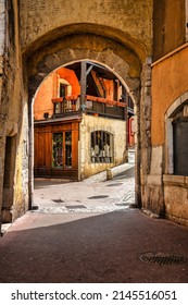Annecy, France - September 21 2020 : street view of an historic medieval french town with architectural facades and the mysterious entrance gate into the town