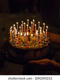 Anniversary Cake With Burning Candles On Dark Background