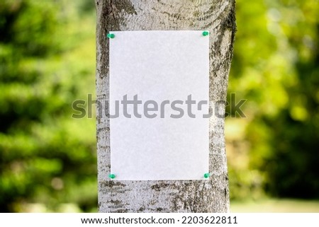 Announcement notice sign blank background pinned on a tree for message