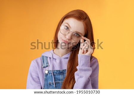Annoyed bossy unimpressed bothered young redhead female coworker smirking tilting head irritated touch glasses look ignorant cringing stupid uninteresting doubtful story not buy any excuses Stock fotó © 