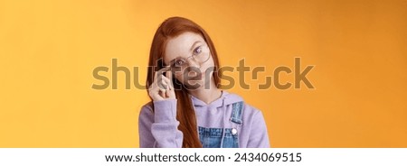 Annoyed bossy unimpressed bothered young redhead female coworker smirking tilting head irritated touch glasses look ignorant cringing stupid uninteresting doubtful story not buy any excuses. Stock fotó © 
