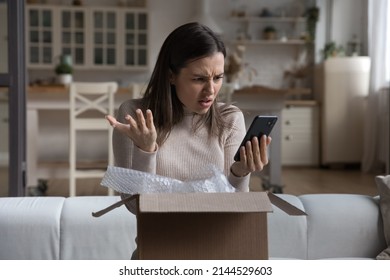 Annoyed Confused Customer Receiving Wrong Parcel From Internet Store, Checking Online App, Internet Service On Mobile Phone. Frustrated Woman, Client, Shopper Opening Box, Using Smartphone