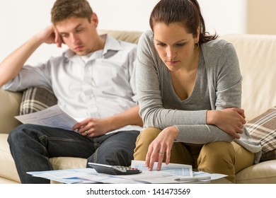 Annoyed couple calculating their finances during recession - Powered by Shutterstock