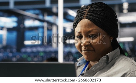 Annoyed data center admin having trouble doing node tree programming. Irked woman in server room having glitching issues while using predictive AI visualization systems on notebook, camera B closeup