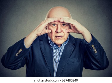 Annoyed Elderly Man Looking Through Hands Like Binoculars Has Vision Problems  