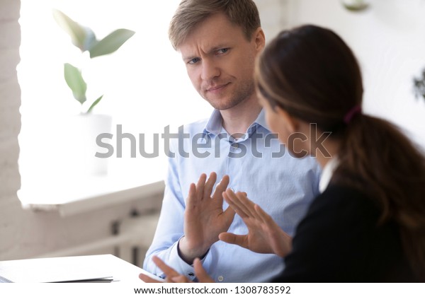 Annoyed man discussing working moments and\
disagreed with colleague. Hr manager showing with hands gesture\
protest and rejection want to finish unsuccessful job interview.\
Bad first impression\
concept
