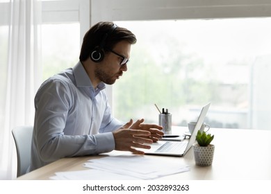 Annoyed Office Employee In Headphones Concerned About Problems With Laptop. Angry Computer User Looking At Screen, Getting App Or Services Errors Notice, Shocking Bad News, Feeling Stress At Workplace