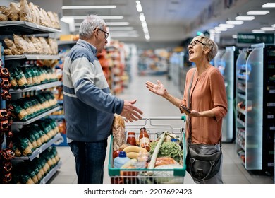 Annoyed senior woman arguing with her husband while buying groceries in supermarket. - Powered by Shutterstock