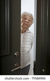 Annoyed Senior Woman Opening Front Door